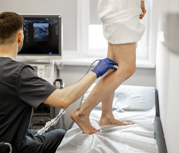 A Boca Raton vein specialist performs varicose vein ultrasound at a treatment center.