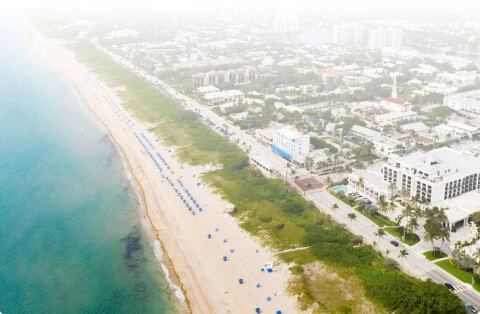 Aerial view of Boca Raton with vein treatment center near beach umbrellas.