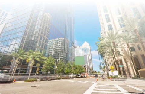 Boca Raton vein treatment center among glass buildings and palm trees, vein care.